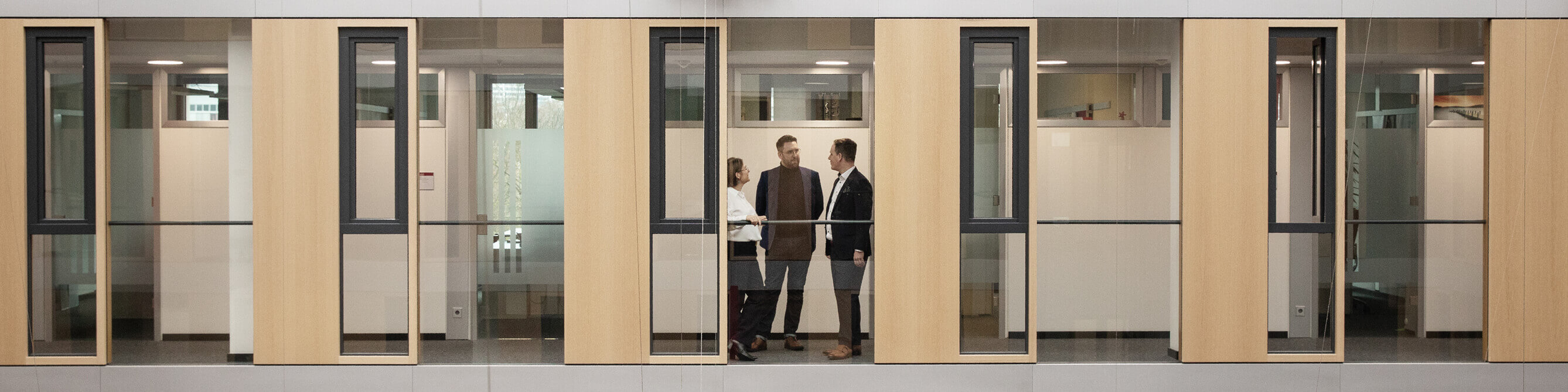 Drei Mitarbeiter der SV tauschen sich im Flur aus