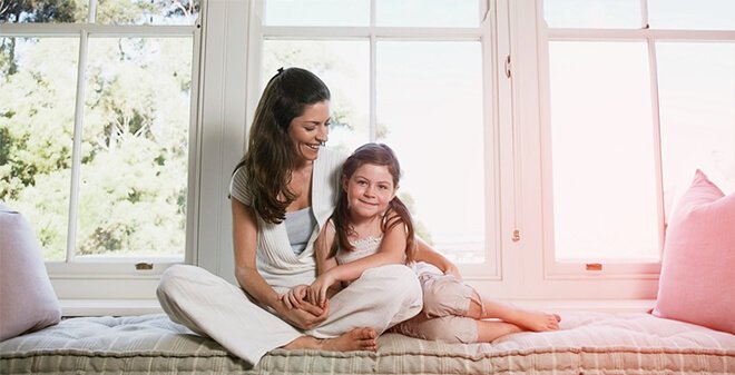Frau sitzt mit ihrer Tochter auf dem Sofa – Hausratversicherung | SV SparkassenVersicherung